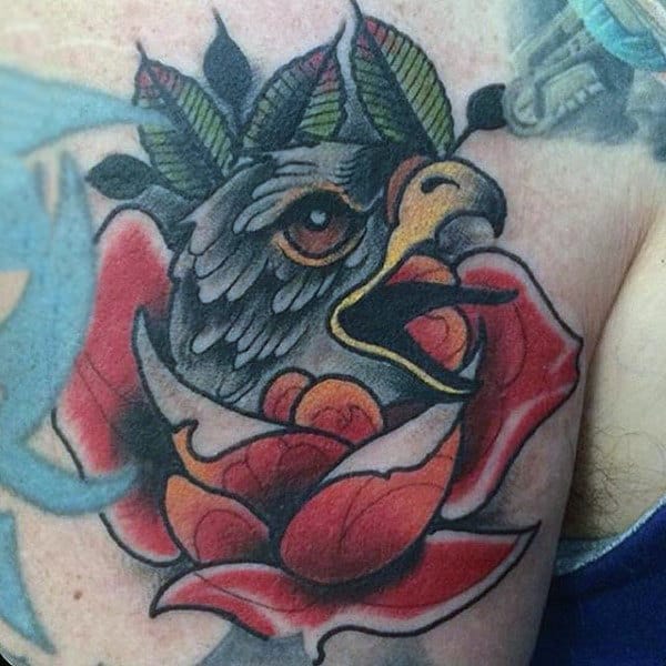 Guy With Colorful Screaming Hawk In Flower Tattoo On Upper Arm