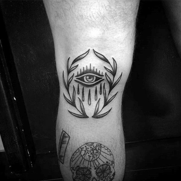 Guy With Crying Eye Laurel Wreath Tattoo Design On Knee Cap