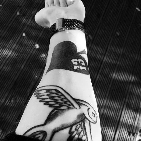 Guy With Dark Block Spade And Bird Tattoo Forearms Design Ideas