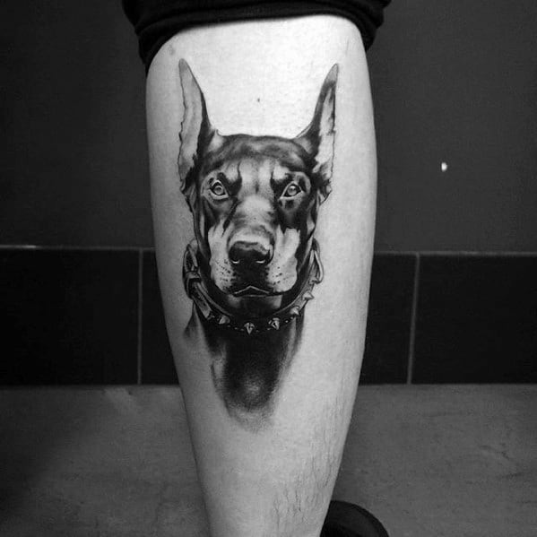 Guy With Dog Doberman Tattoo Design On Leg Calf