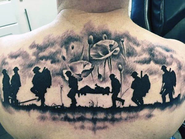 Guy With Fallen Solider Being Carried Poppy Flower Back Tattoo