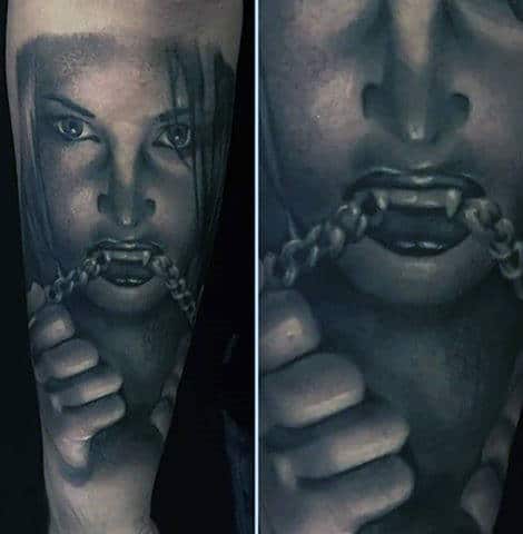 Guy With Female Vampire Biting Chain Tattoo On Lower Forearm