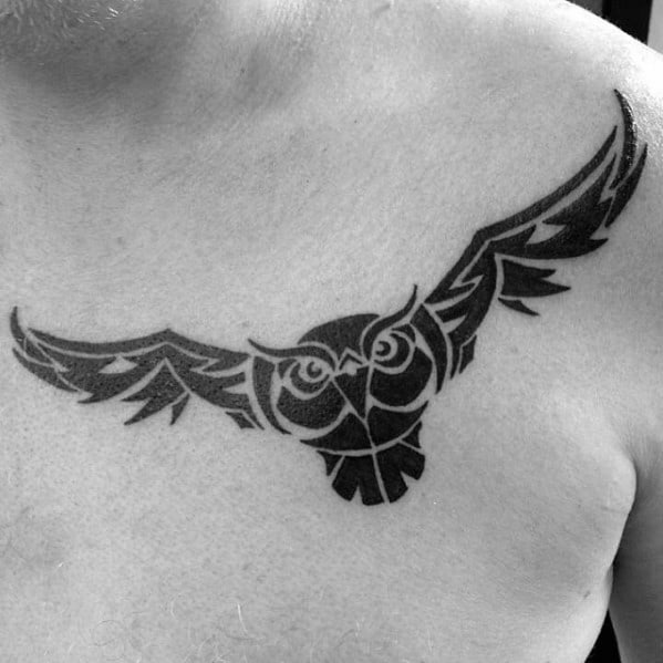 Guy With Flying Black Ink Tribal Owl Tattoo On Upper Chest