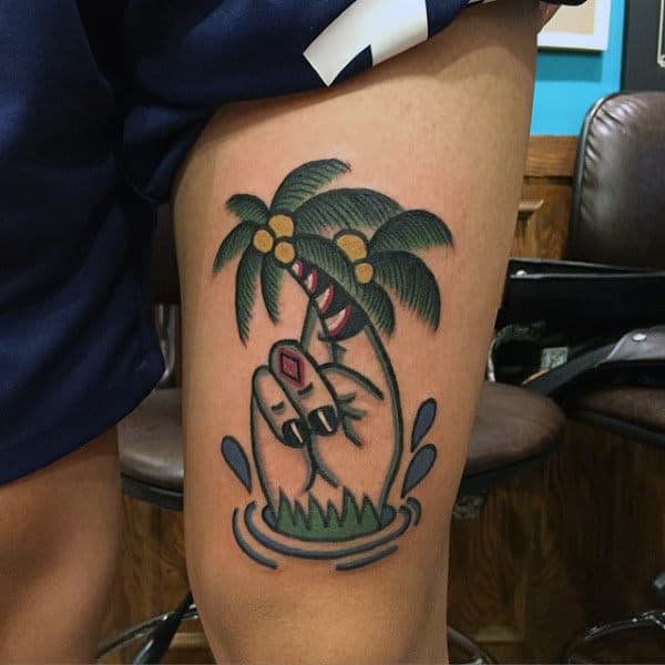 Guy With Funky Palm Tree Tattoo On Thighs