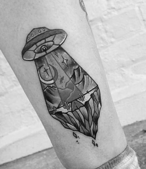 Guy With Grey Black Ufo Tattoo On Lower Legs