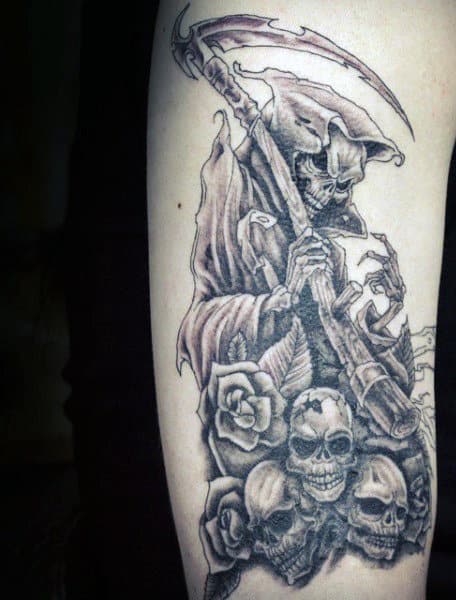 Guy With Grim Reaper Tattoo And Skulls