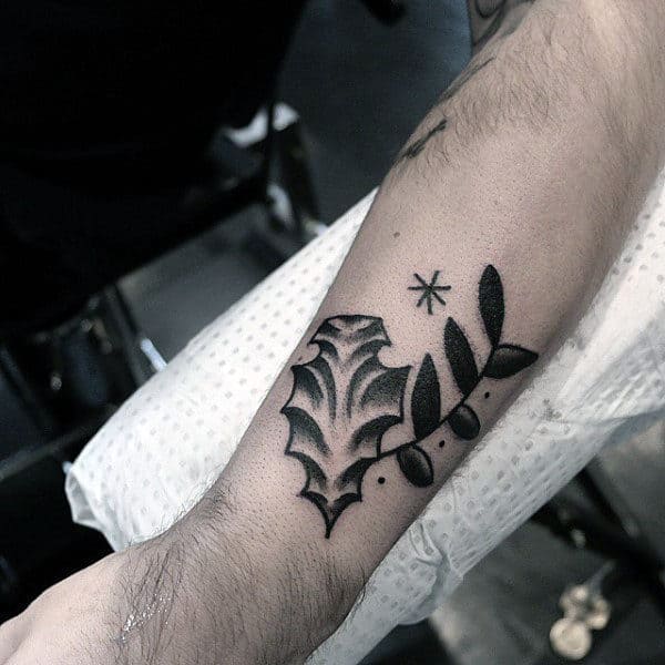 Guy With Leafy Arrowhead Tattoo On Forearms