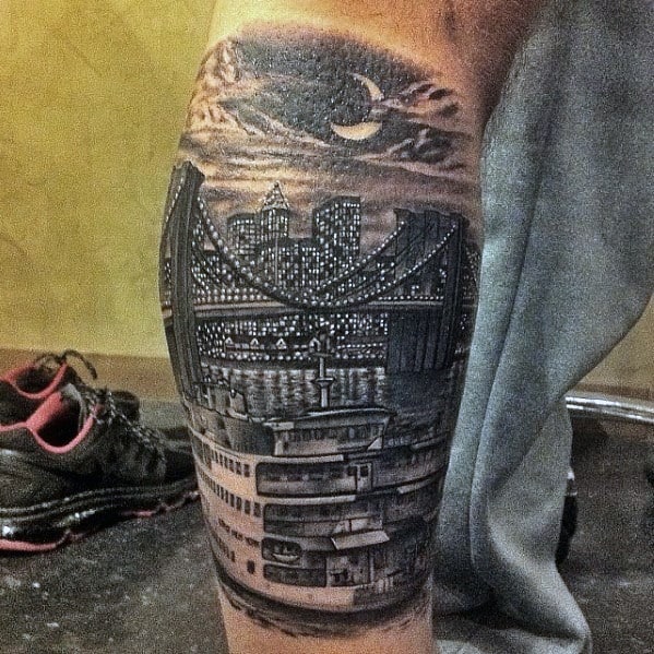 Guy With New York Skyline Tattoo Design On Leg