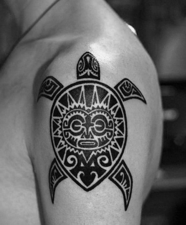 Guy With Ornate Tribal Turtle Tattoo Design On Upper Arm