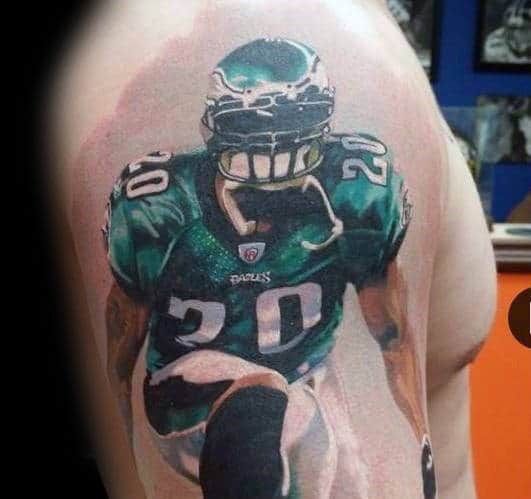 Guy With Philiadephia Eagles Football Player Tattoo On Arm