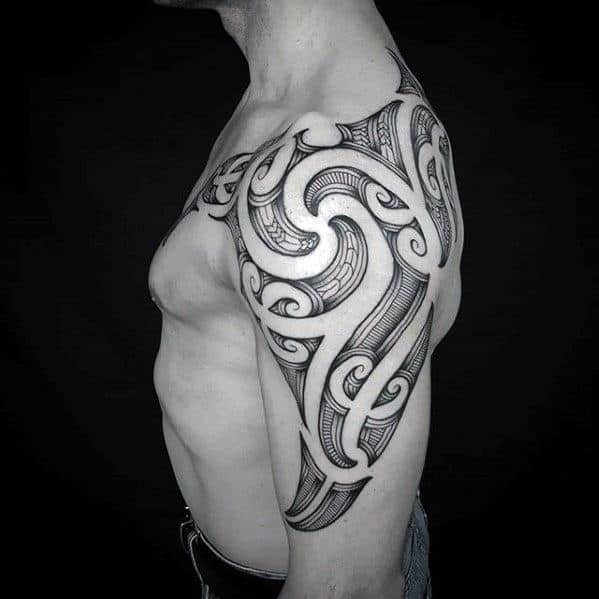 Guy With Polynesian Negative Space Tribal Arm And Shoulder Tattoo