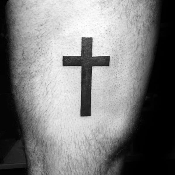 Guy With Simple Cross Black Ink Thigh Tattoo