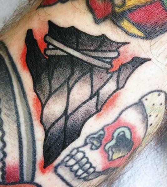 Guy With Skull And Arrowhead Tattoo On Arms