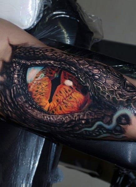 Guy With Snake Skinned Orange Eye Tattoo On Arms