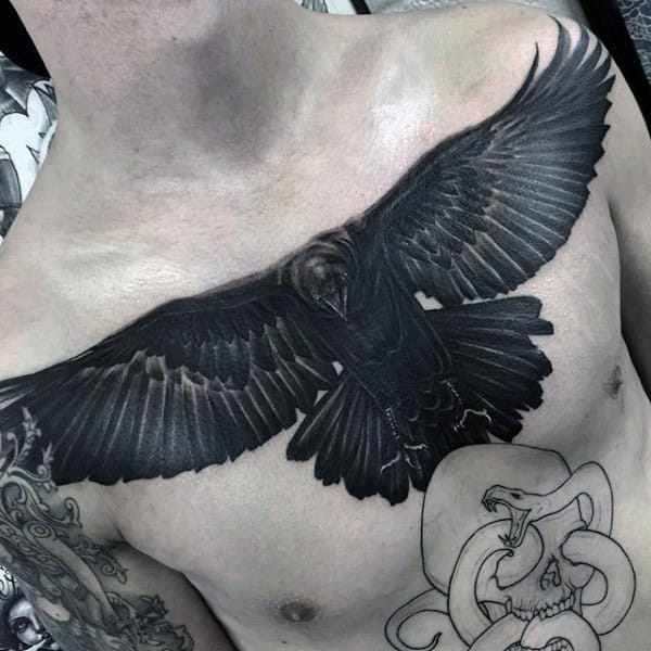 Guy With Sooty Black Raven Tattoo On Chest