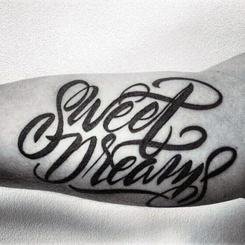 Guy With Sweet Dreams Lettering Tattoo On Arms