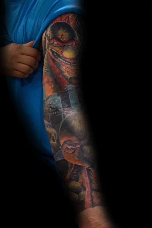 Guy With Tattoo Of Teenage Mutant Ninja Turtles On Full Arm Sleeve