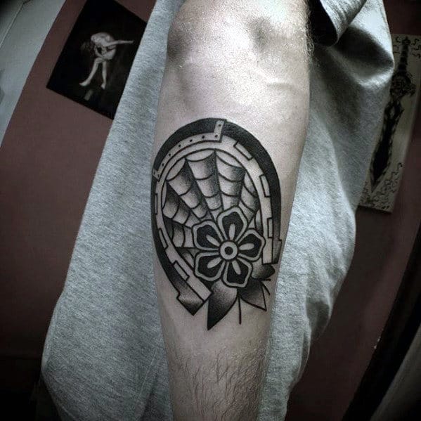 Guy With Traditional Horseshoe Flower Black Ink Outer Forearm Tattoo