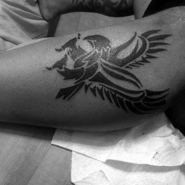 Guy With Tribal Eagle Tattoo On Legs
