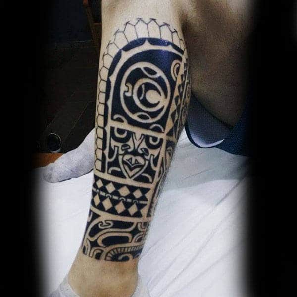 Guy With Tribal Leg Tattoo In Black Ink
