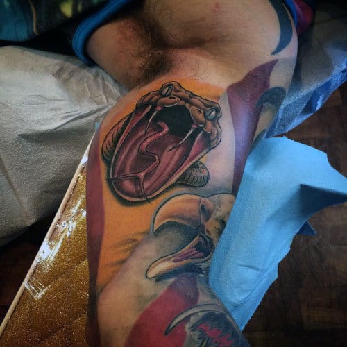 Guys Angry Snake In Traditional Style Bicep Tattoo