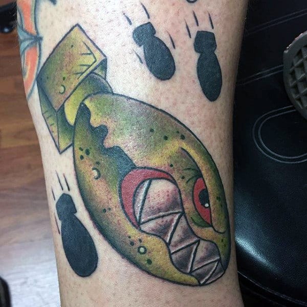 Guys Ankles Green Fish And Black Bombs Tattoo