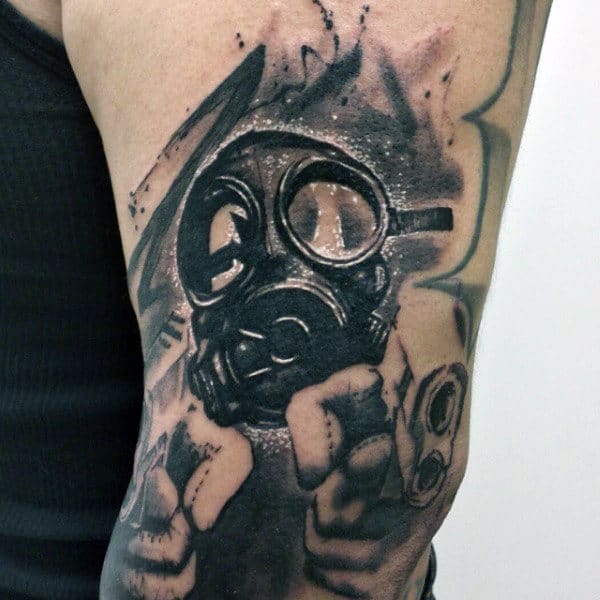 Guys Gas Mask Gun Tattoo On Upper Arm
