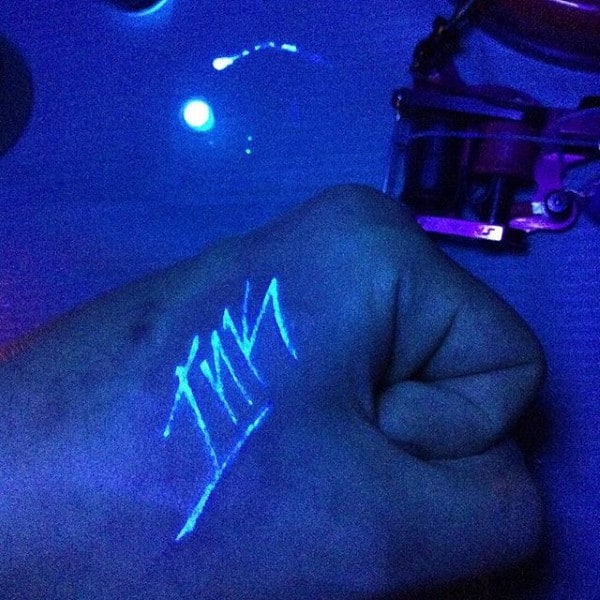 Guys Glow In Dark Hand Tattoo With Lettering Of Ink