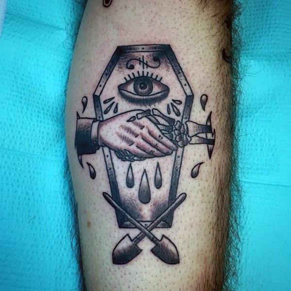 Guys Handshake Eye Shovel Coffin Tattoo On Legs