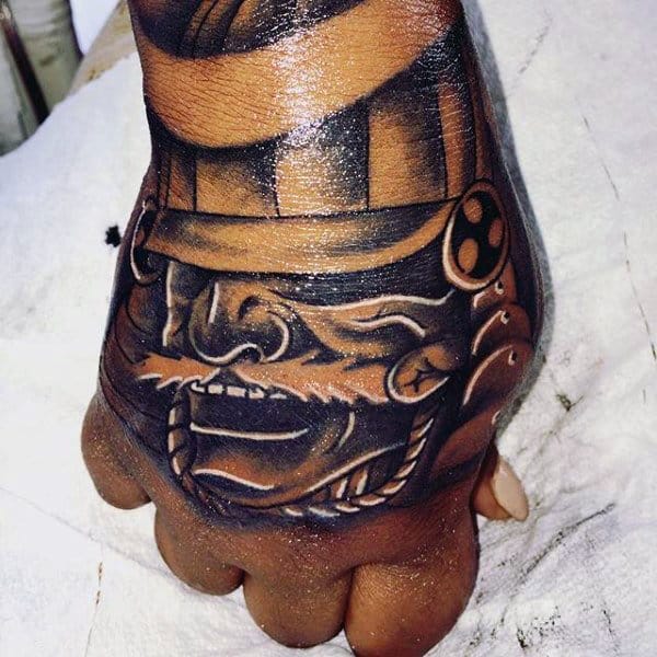 Guys Laughing Samurai Mask Tattoo On Hand In Traditional Japanese Style
