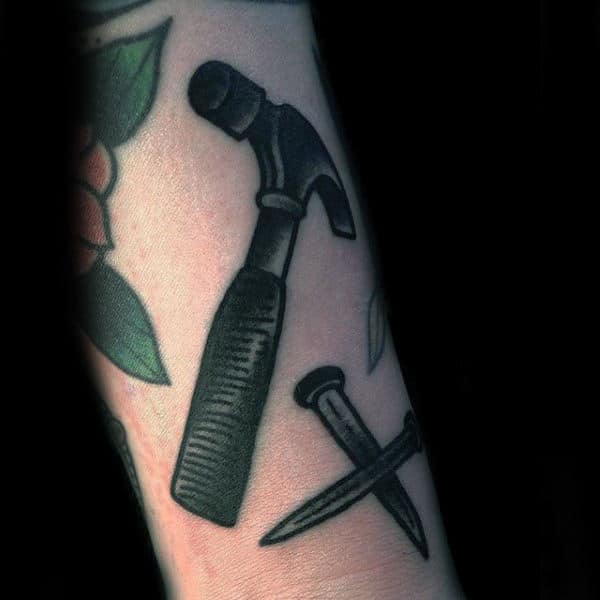 Guys Old School Black Ink Shaded Hammer And Nail Tatoto On Wrist