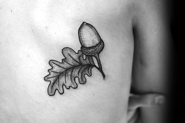 Guys Small Back Tattoo Of Acorn With Dotwork Design