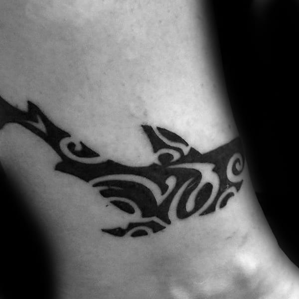 Guys Small Wrist Tattoo Of Tribal Shark With Negative Space Design