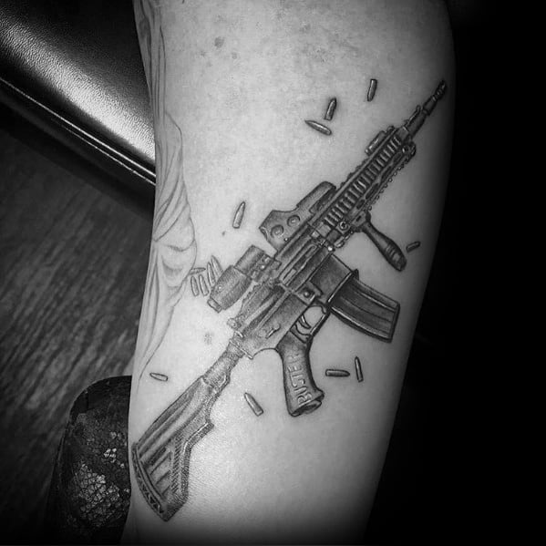 Guys Tattoo Ar 15 Rifle Design On Arm.