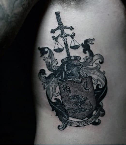 Guys Tattoo Of Family Crest In Black Ink