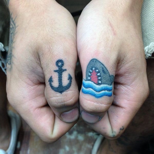 Guys Thumb Tatto Of Anchor And Shark