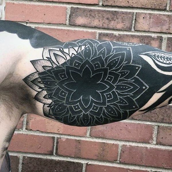Guys White Ink Flower Over All Black Bicep Tattoo