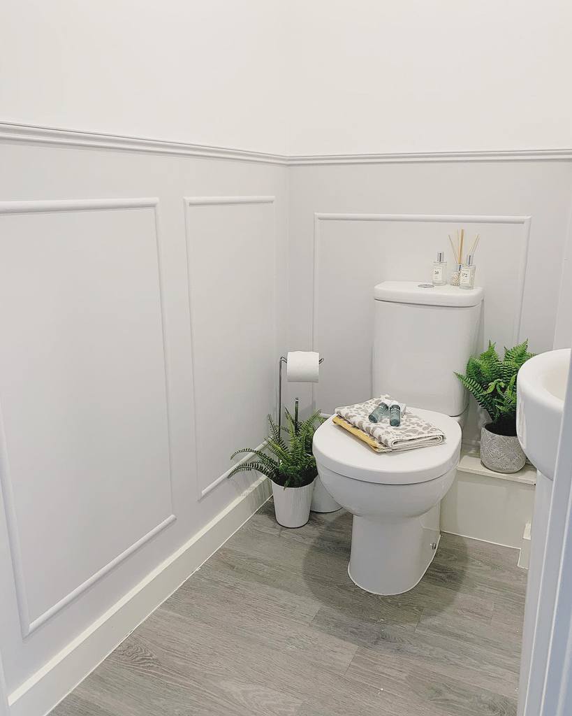 half wall white paneling toilet