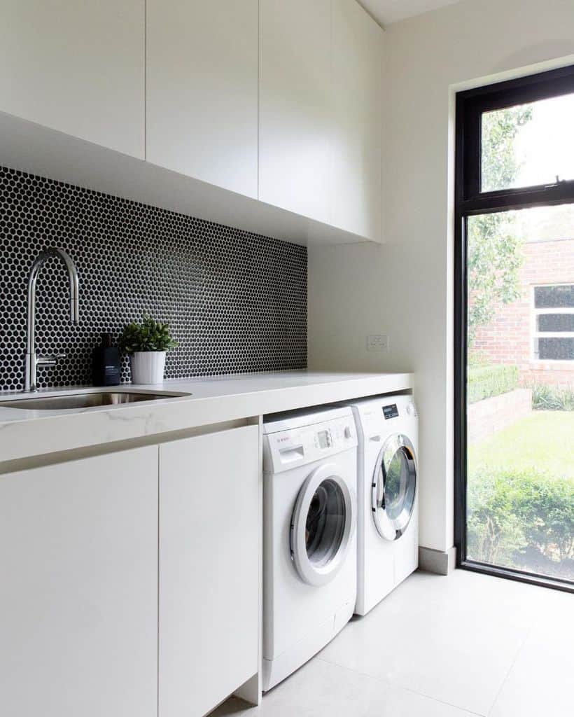 hallway laundry room storage white cabinets tile backsplash