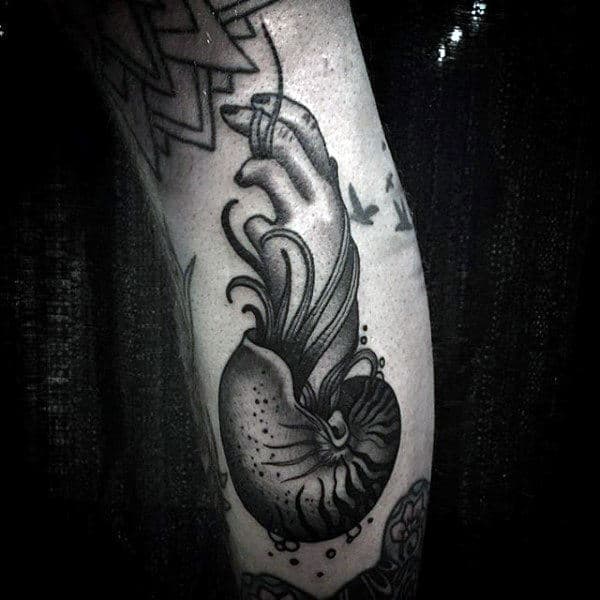 Hand Coming Out Of Spiral Seashell Tattoo For Mens Arms
