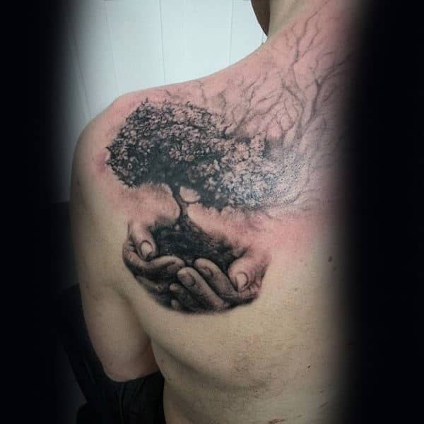 Hand Holding Tree Of Life Realsitic Mens Upper Back Tattoo