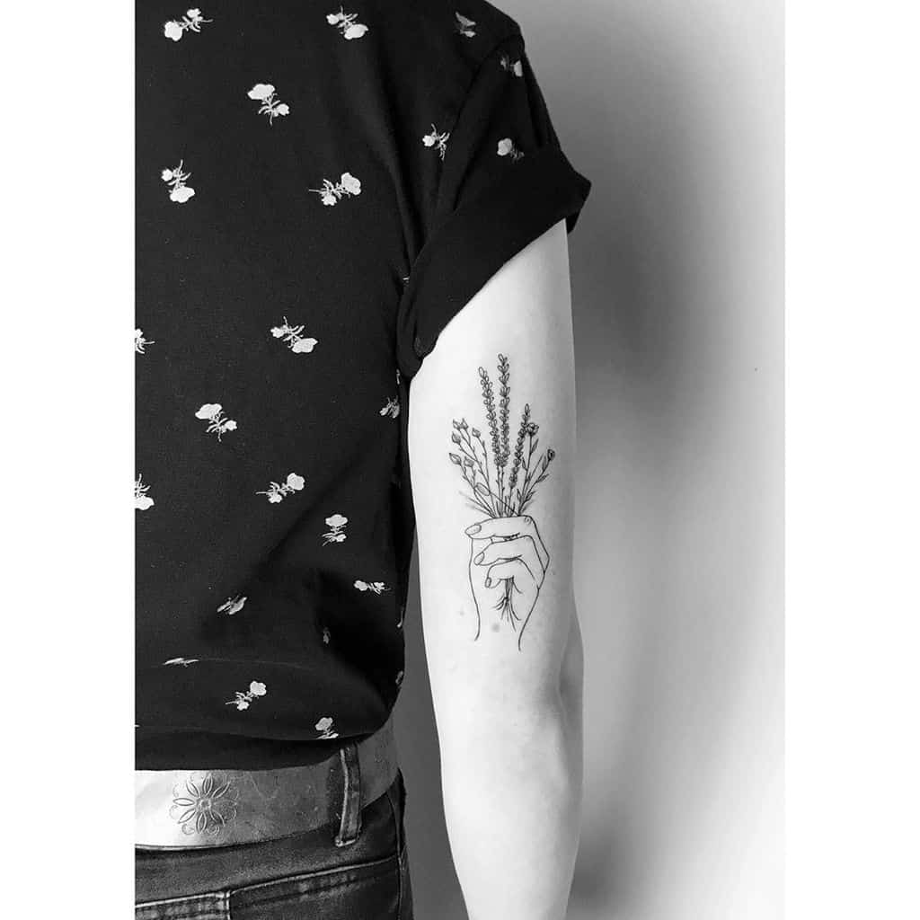 Hand Holding Wildflower Lavander Tattoo