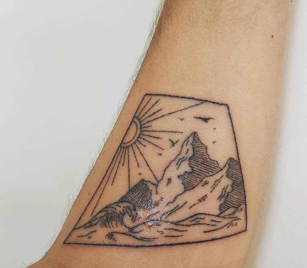 handpoke-mountains-sun-ocean-tattoo-ashleighjayneart
