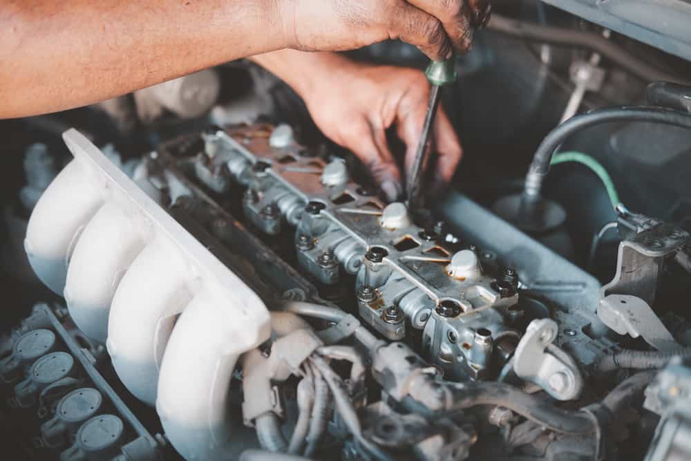 hands of car mechanic in auto repair service