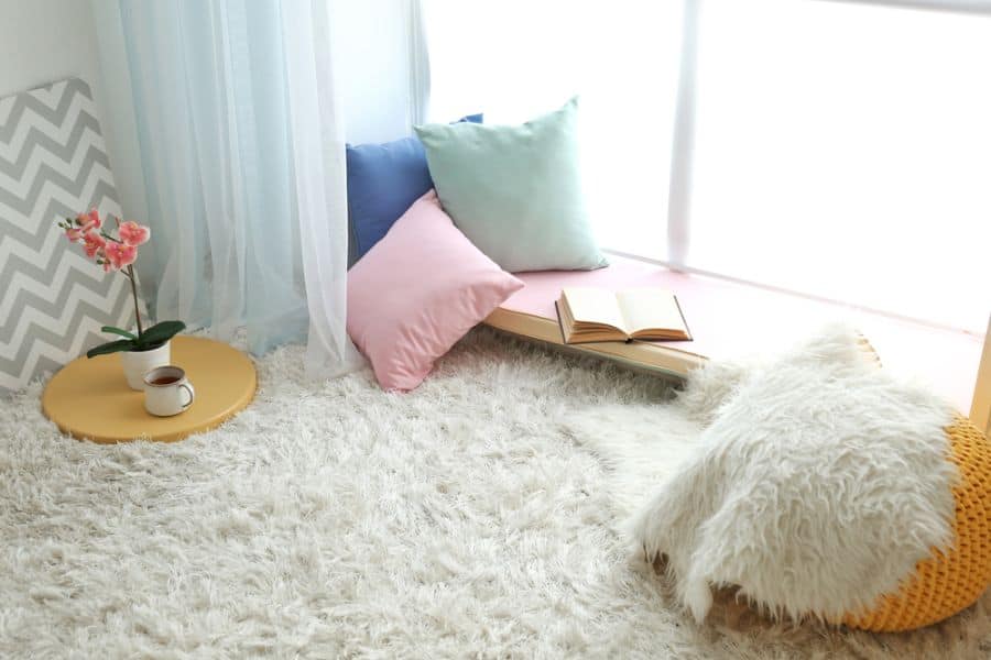 small window reading nook with pillows 