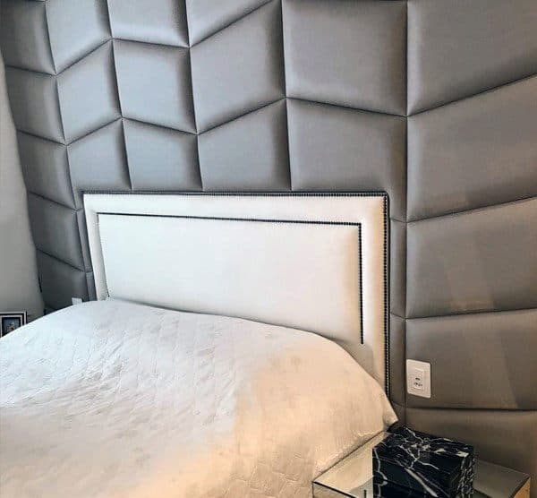 small white headboards gray padded wall