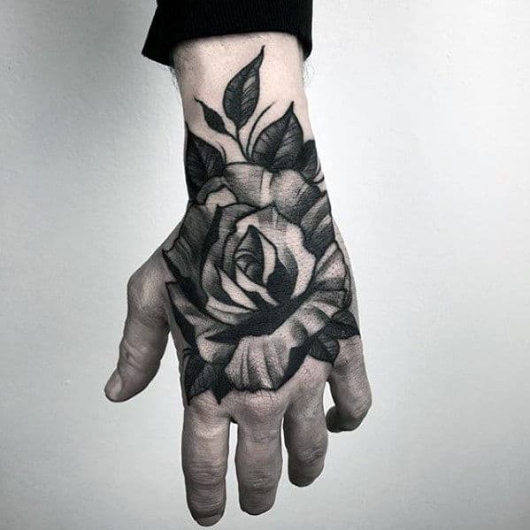 Heavily Shaded Traditional Flower Guys Black And White Ink Hand Tattoo