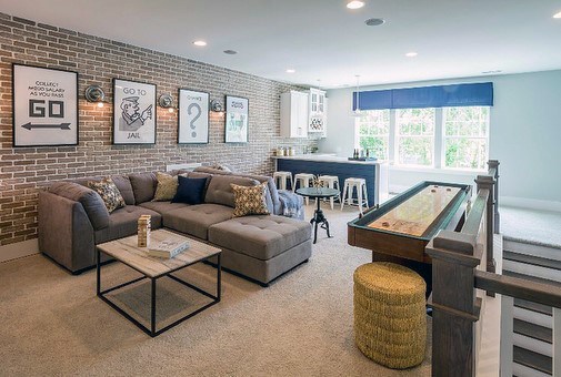 home bar monopoly wall art couch brick feature wall
