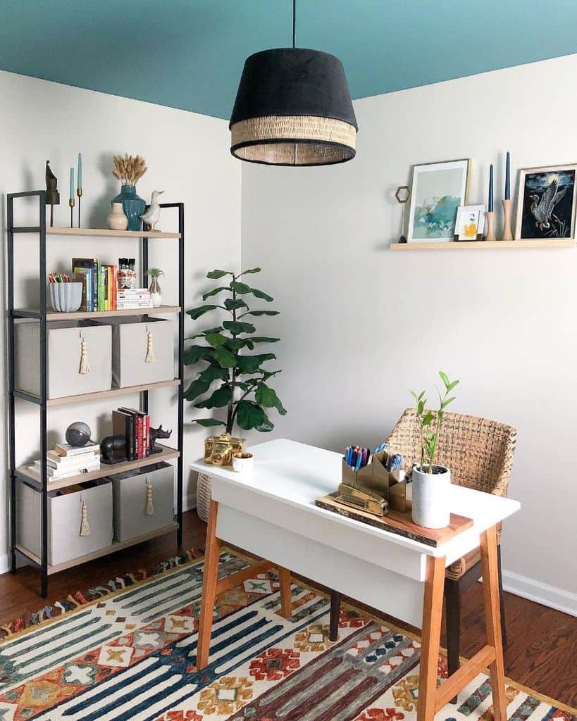 small home office white desk wicker chair black storage shelf unit blue ceiling pot plants 
