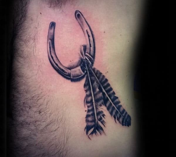 Horseshoe With Feathers Mens Rib Cage Side Of Body Tattoo